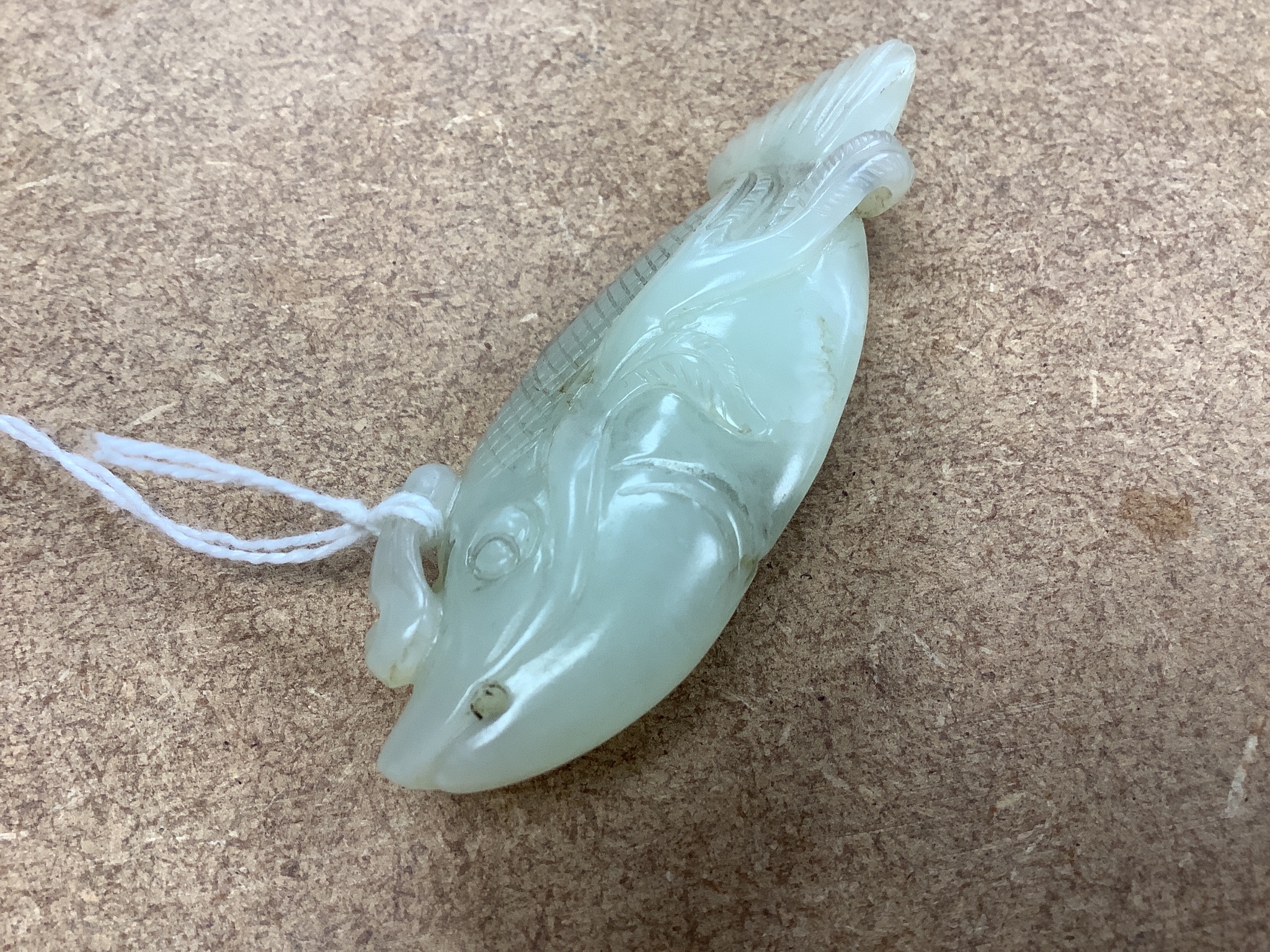 A Chinese pale celadon jade carving of a fish, 8.7 cm